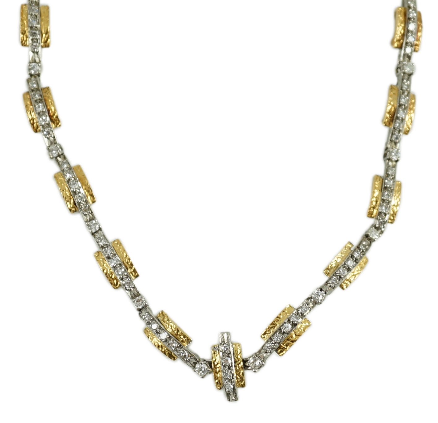 A 20th century two colour gold and diamond set necklace